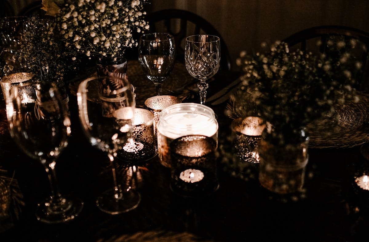 a table topped with candles and cups
