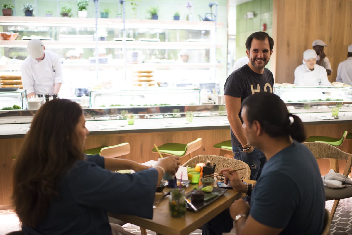 a group of people preparing food in a kitchen