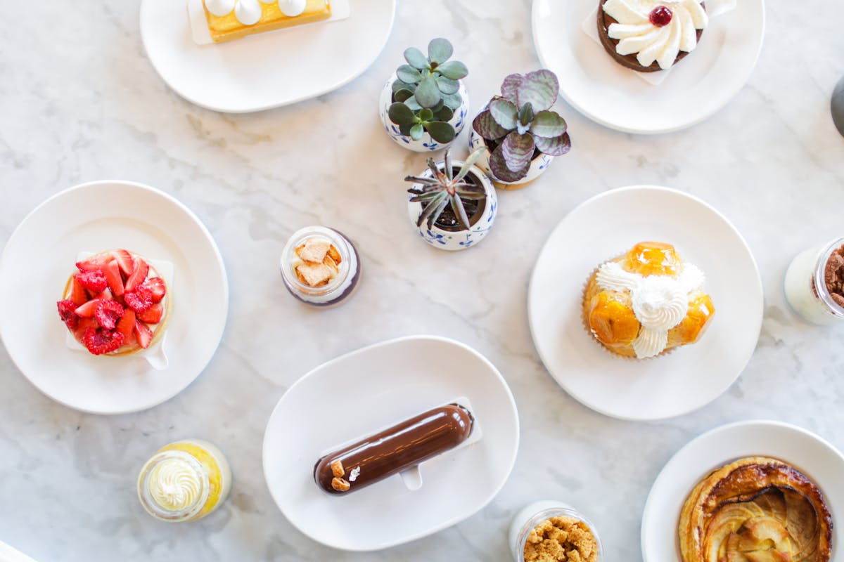 an array of platters topped with different desserts