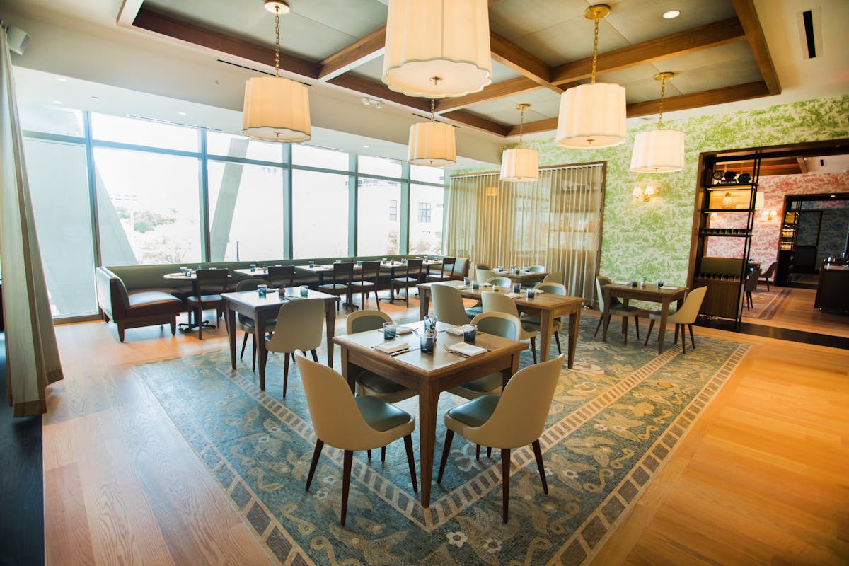 a big dining room filled with dining tables and chairs