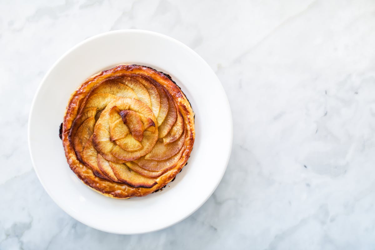 a white plate topped with a cinnamon roll