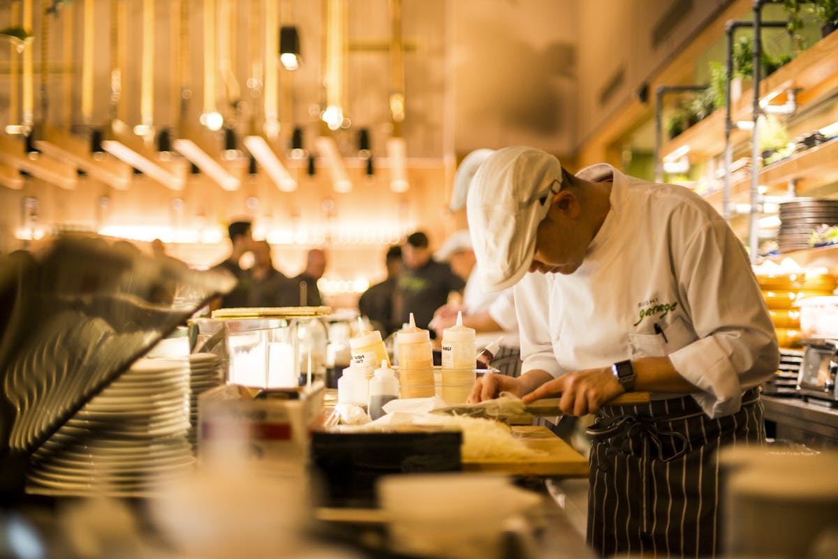 a person cooking in a kitchen preparing food