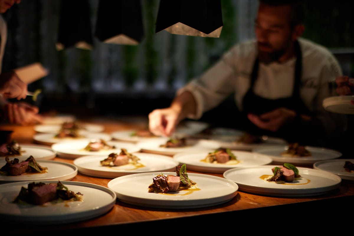 a group of people sitting at a table with a plate of food