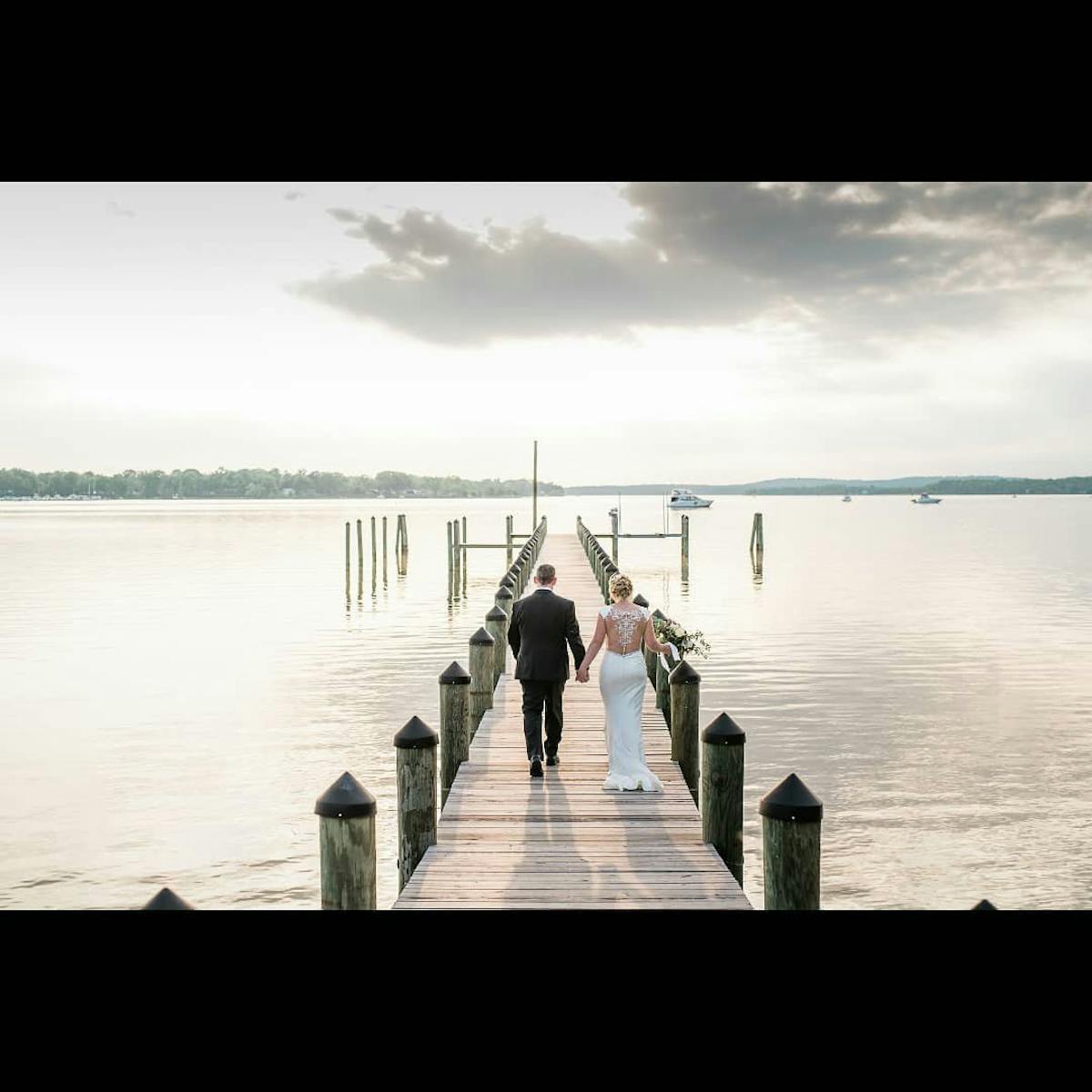 a group of people standing next to a body of water