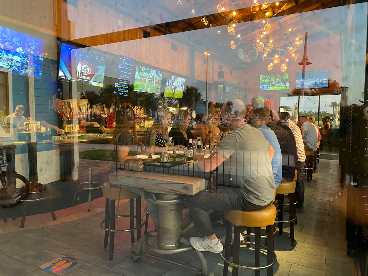 a group of people sitting at a table in a restaurant