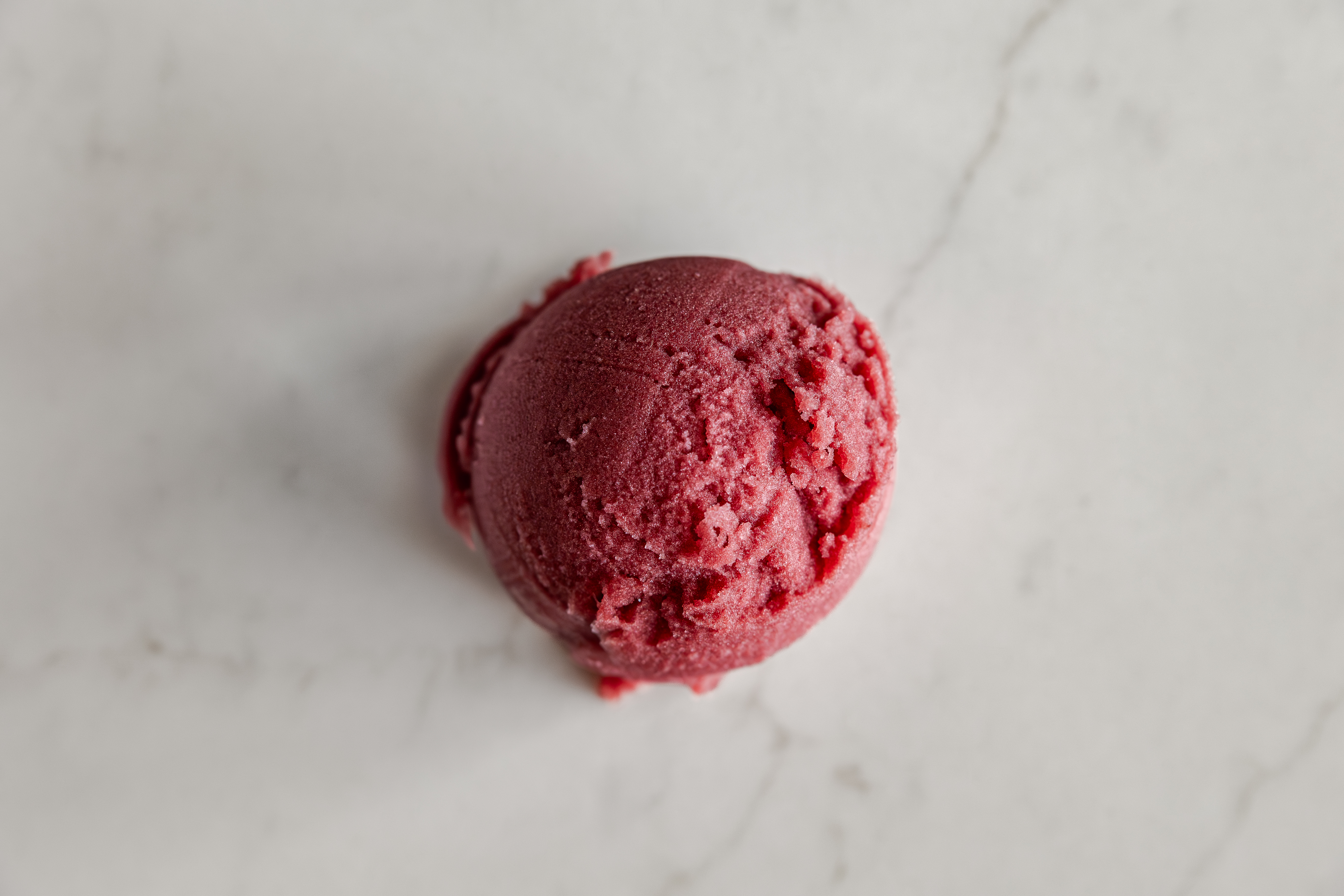 a scoop of blood orange hibiscus italian ice