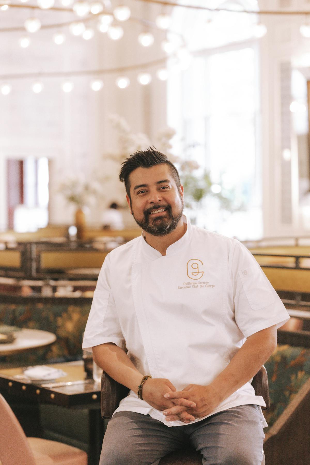 a chef posing and smiling