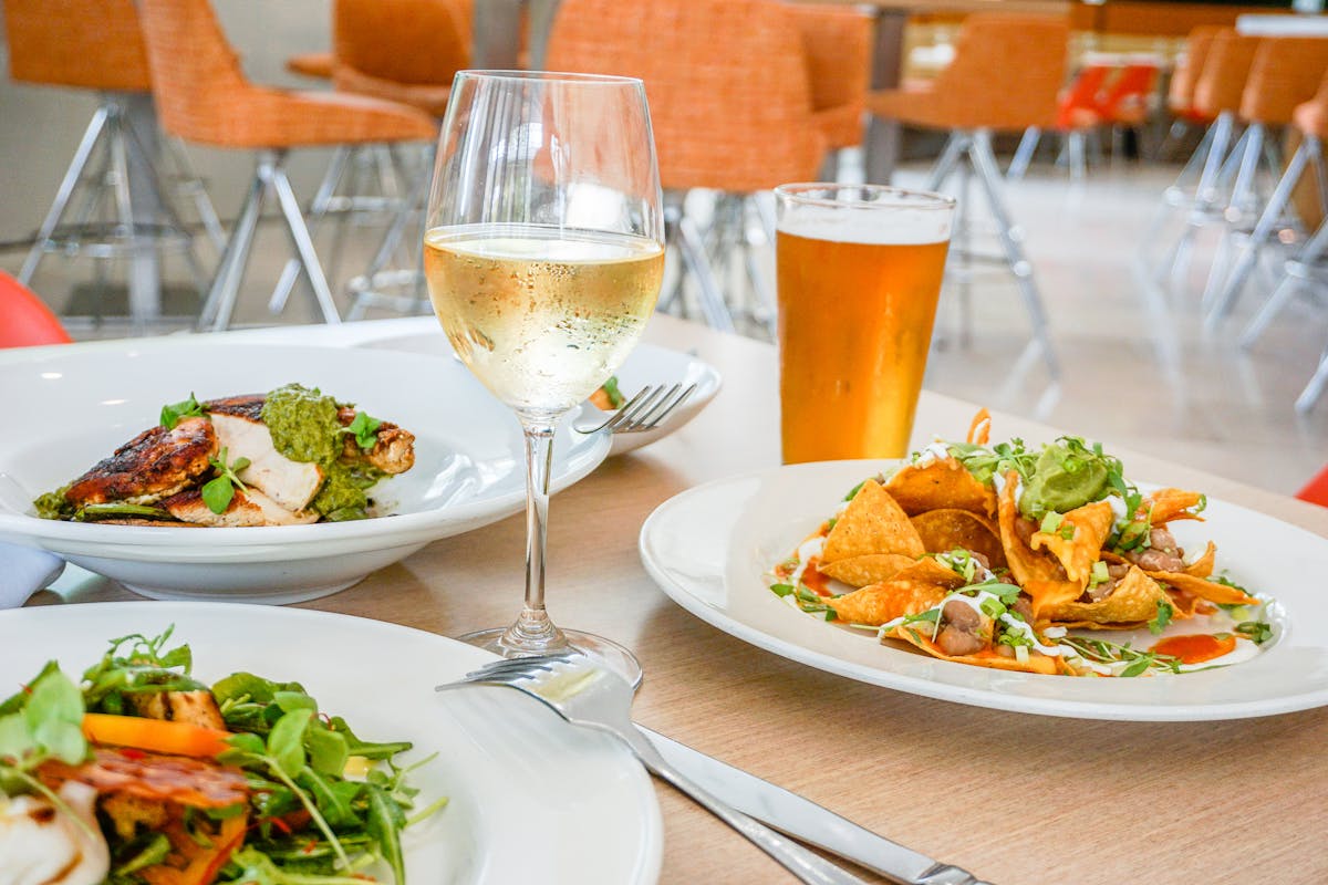 a person sitting at a table with a plate of food