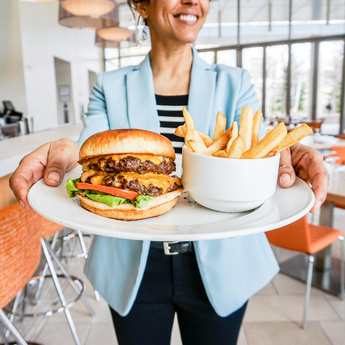 a woman sitting at a table with a plate of food