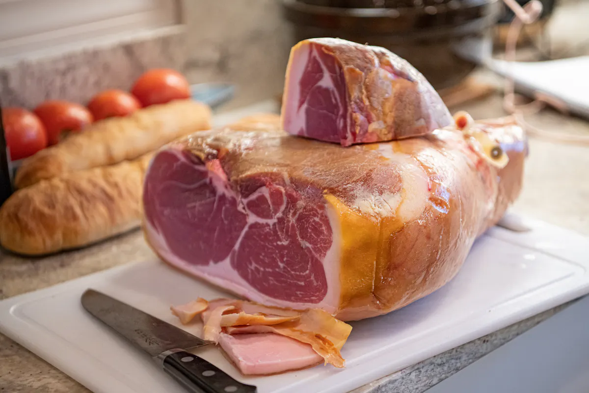 a sandwich sitting on top of a cutting board with a cake