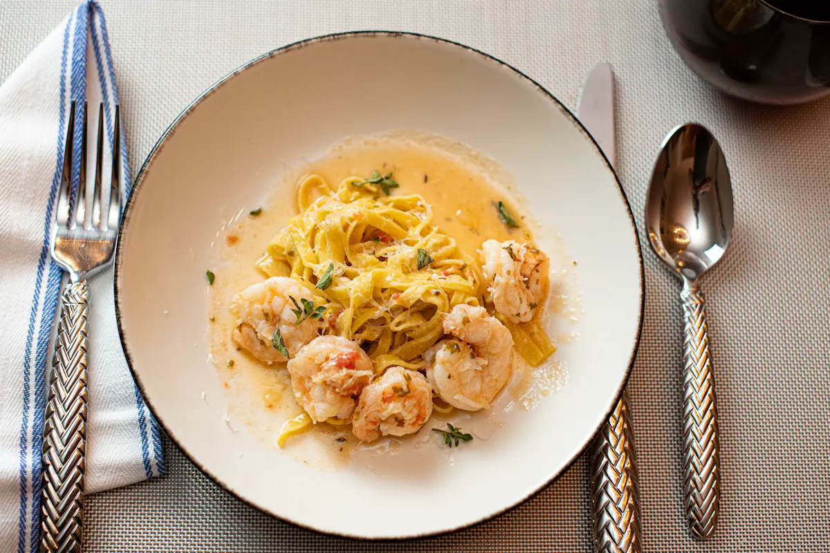 a plate of food and a spoon on a table