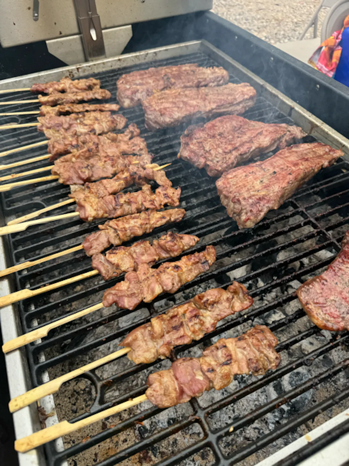 a bunch of hot dogs cooking on a grill
