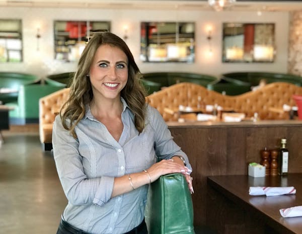 a woman sitting at a table in a restaurant