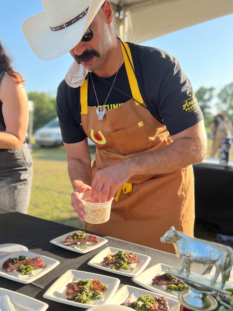 a person sitting at a table with a plate of food