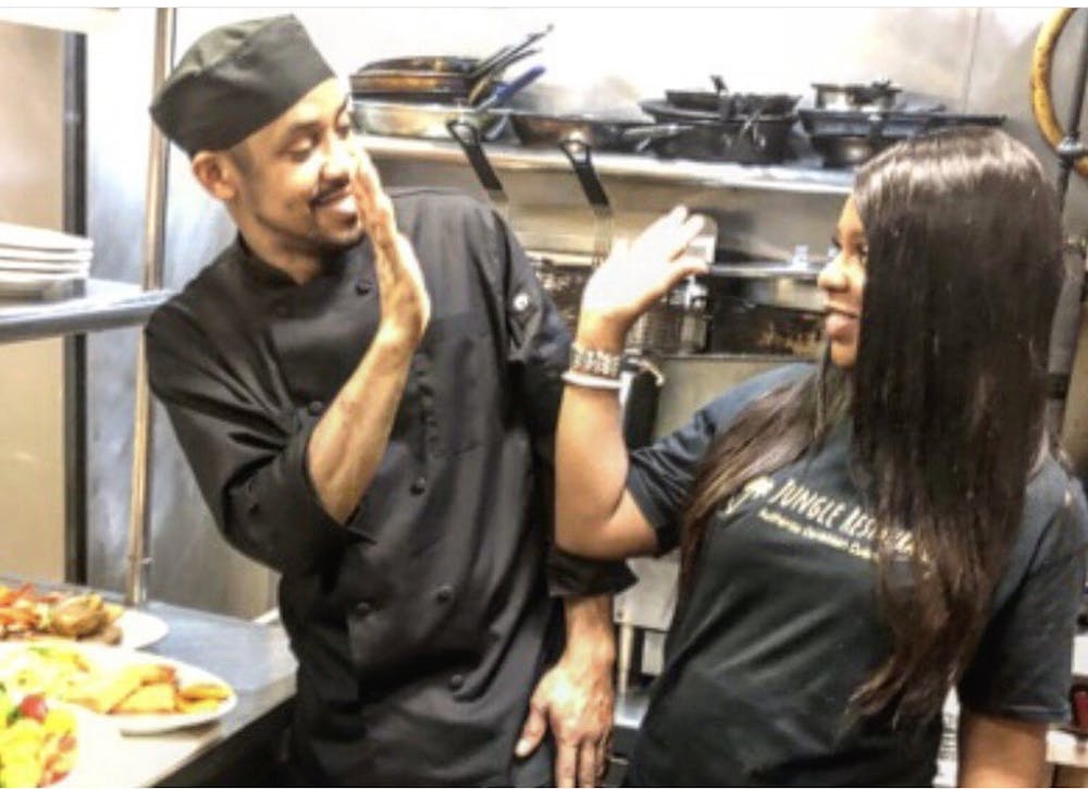 a group of people preparing food in a kitchen