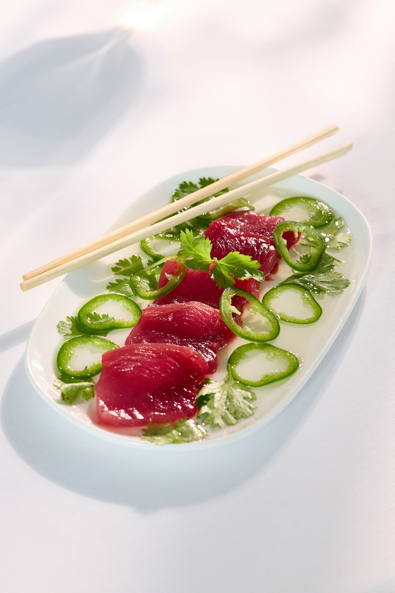 a plate of raw meat and vegetables