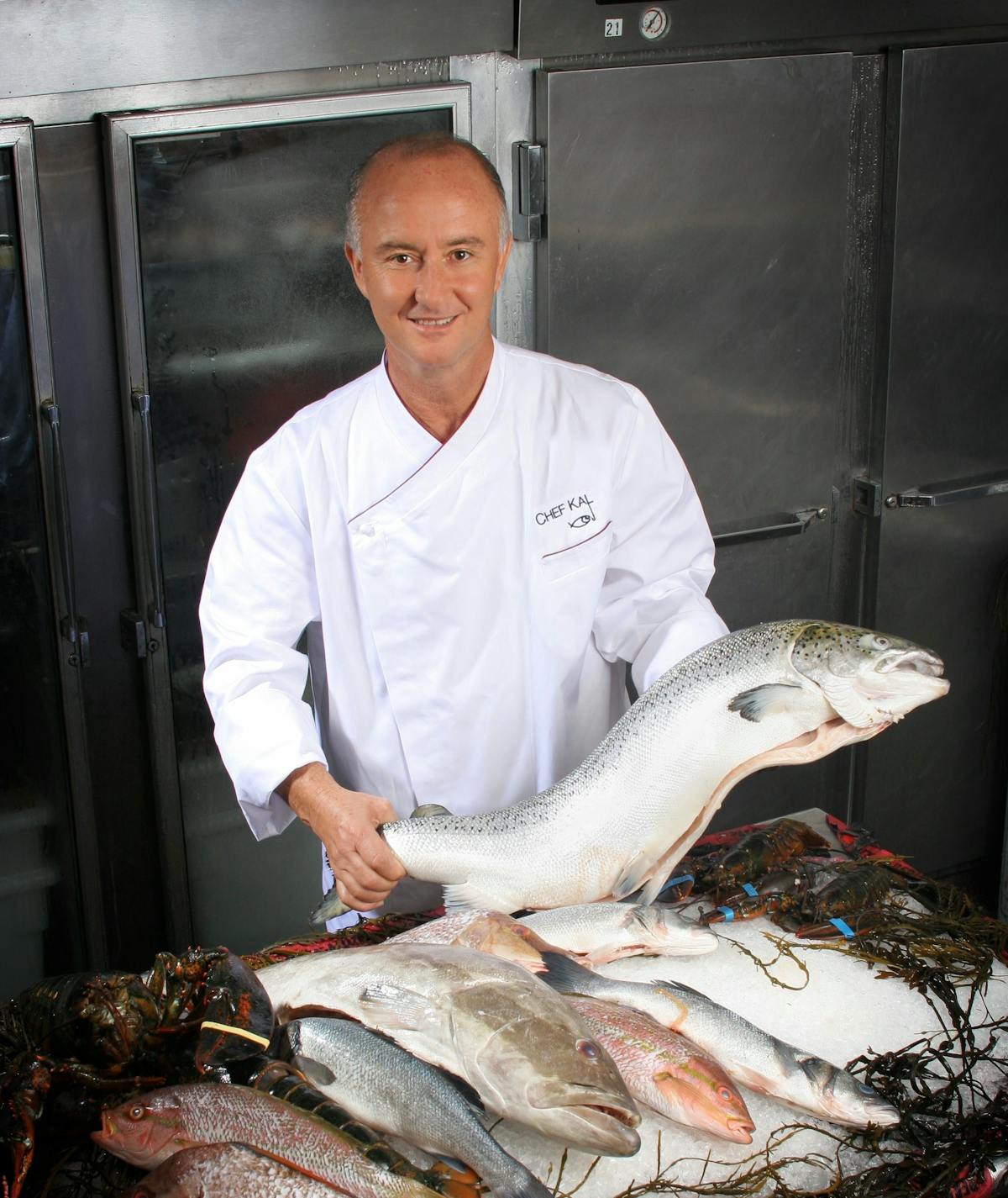 a chef holding a fish