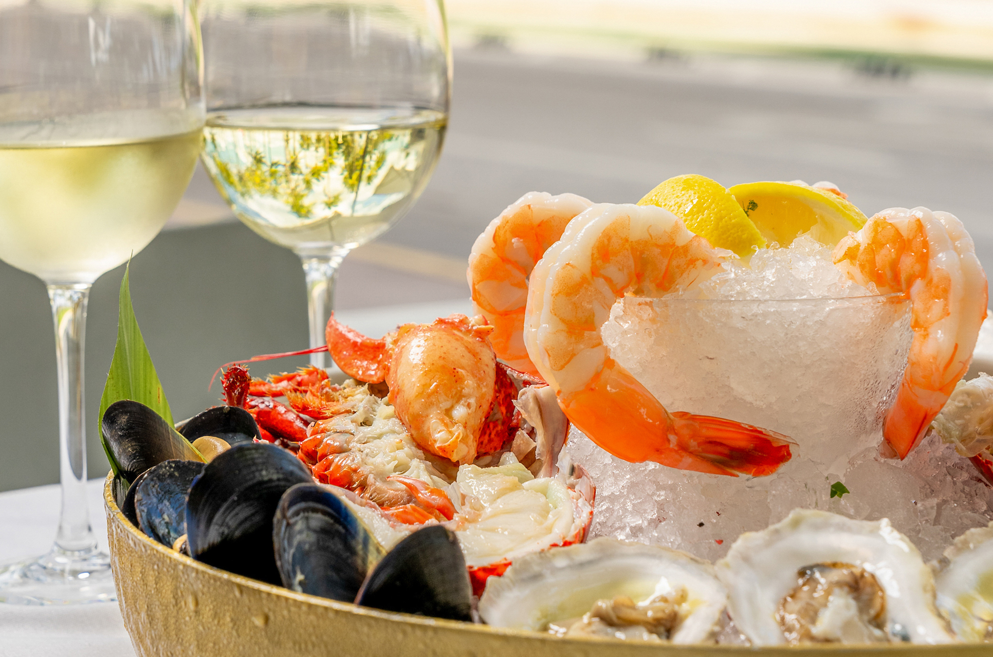 a bowl of seafood with ice and lemons