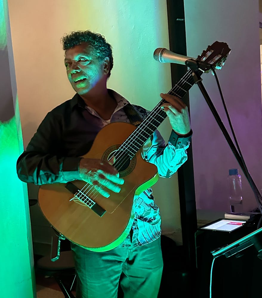 close up of Tony Cruz playing on the guitar