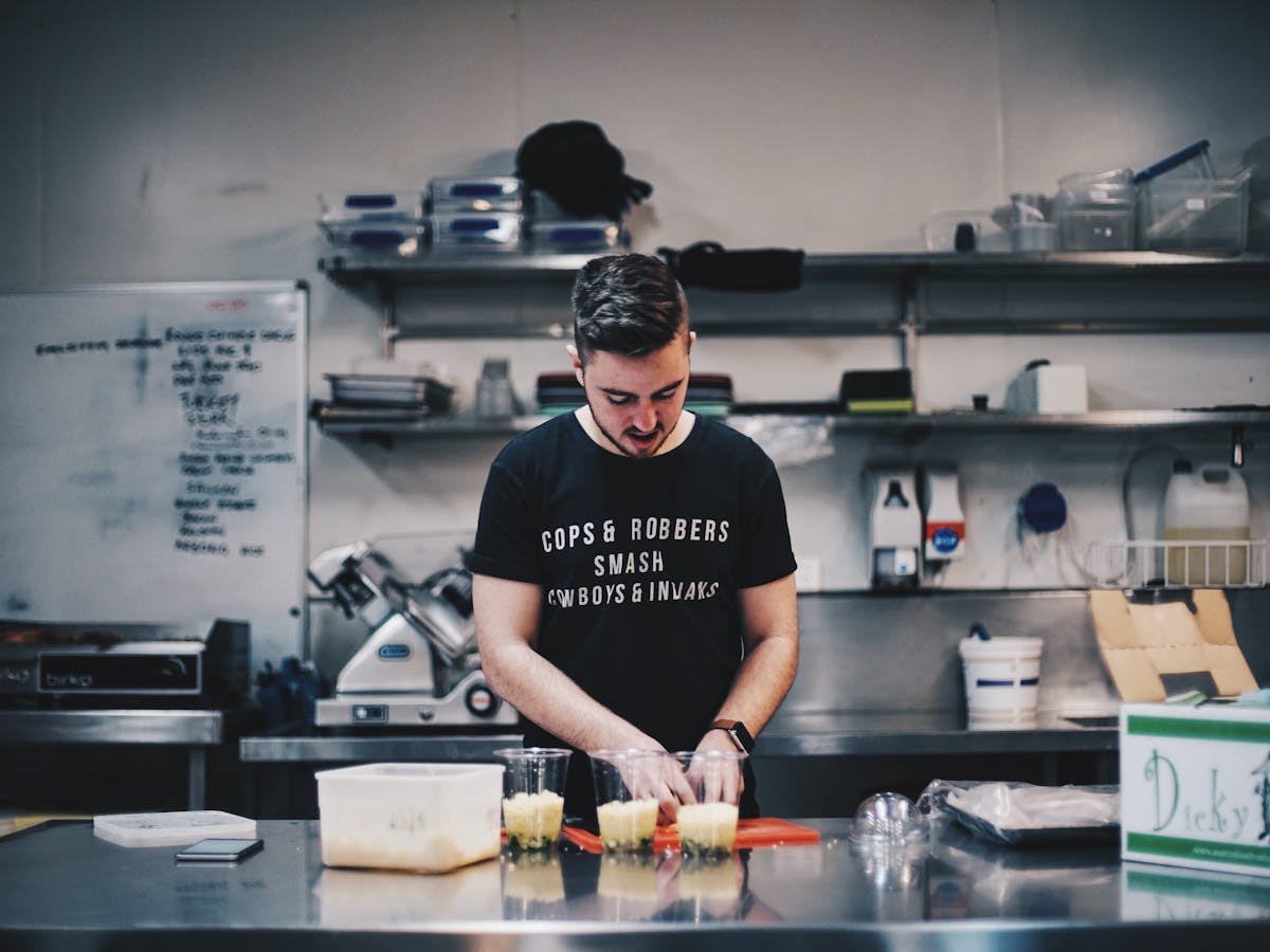Man cooking in a kitchen preparing food