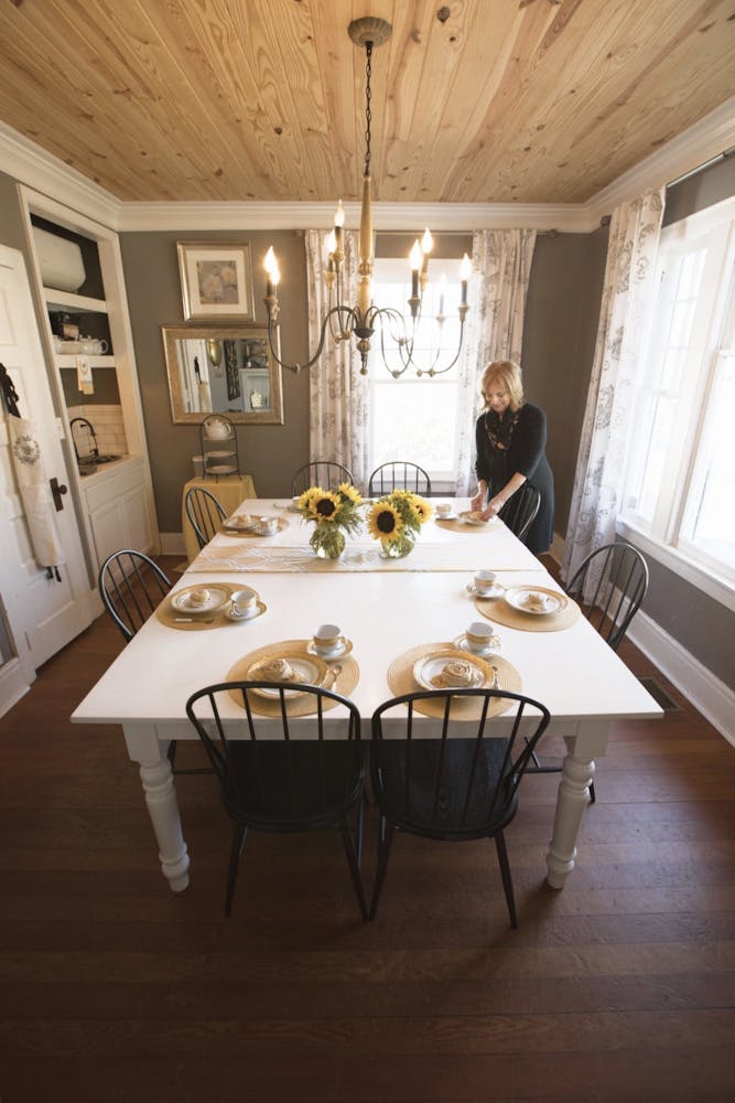 a dining room table in front of a window