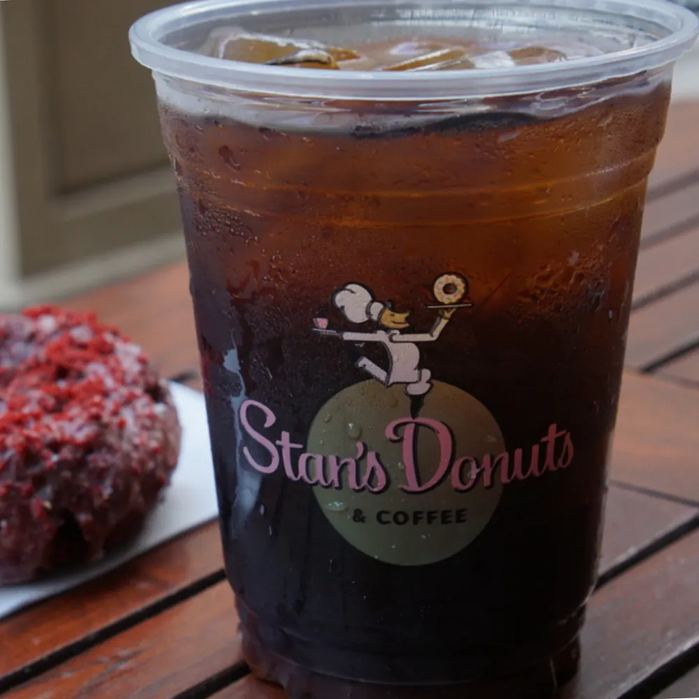 a cup of coffee and a glass of beer on a table