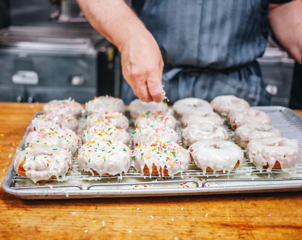 Stan's Donuts & Coffee a man cooking pizza