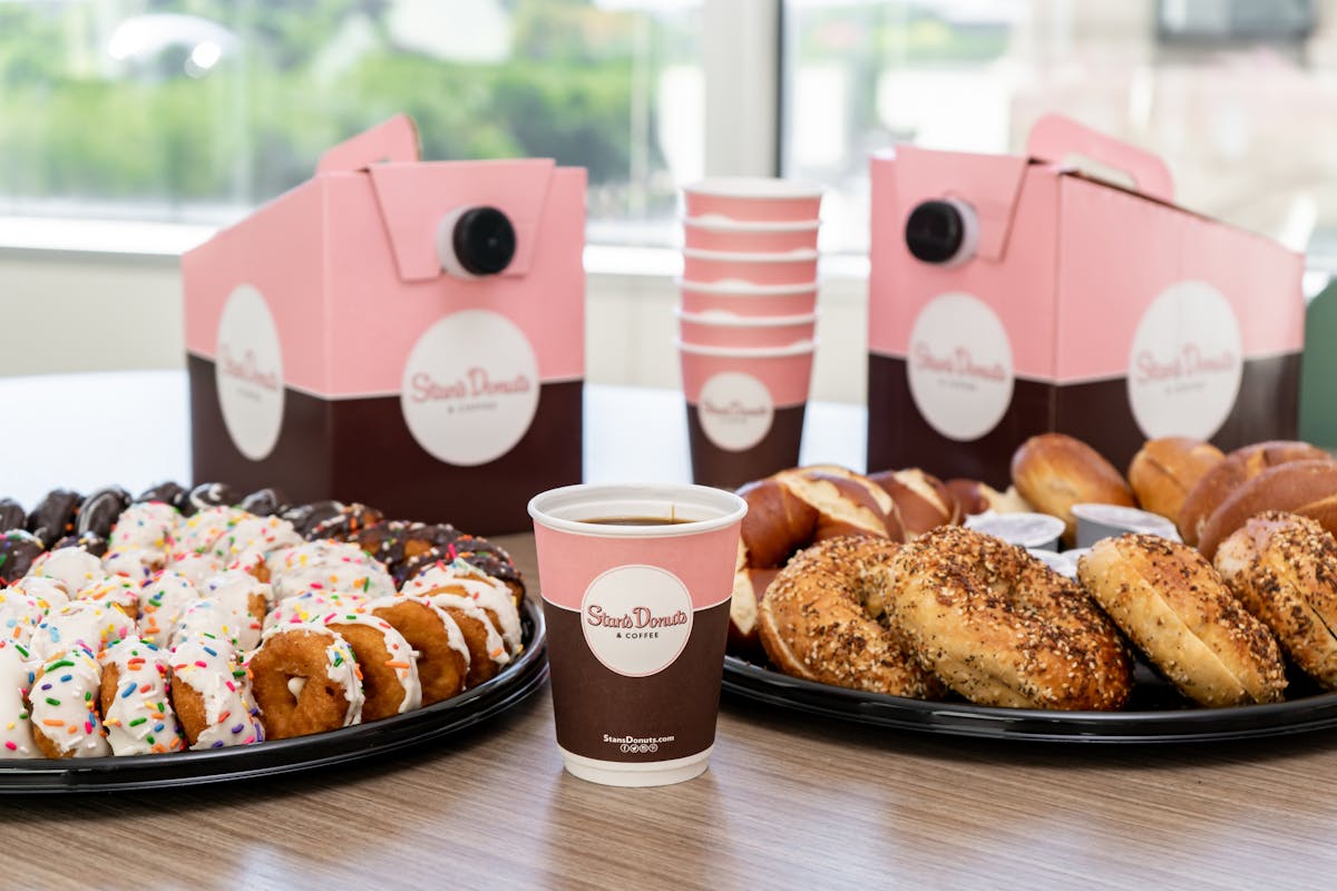 a pink box filled with different types of food on a table
