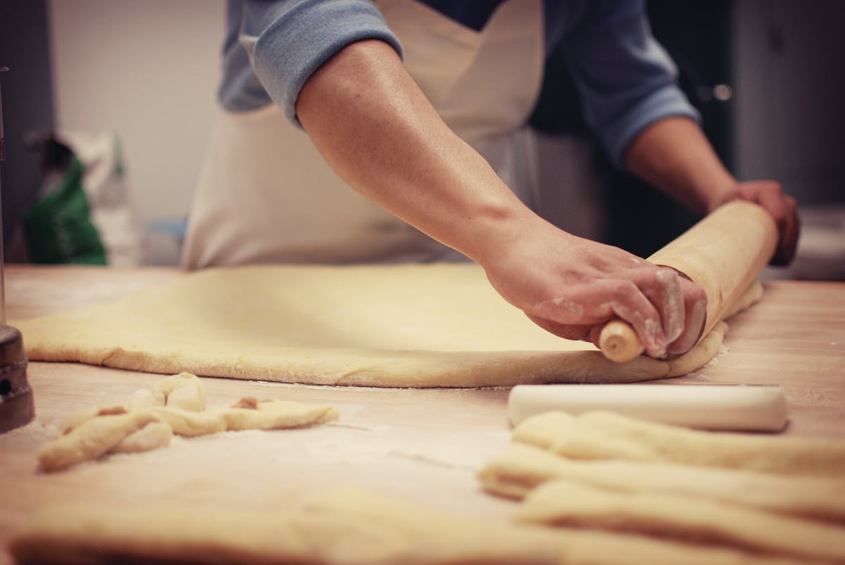 someone kneading donut dough