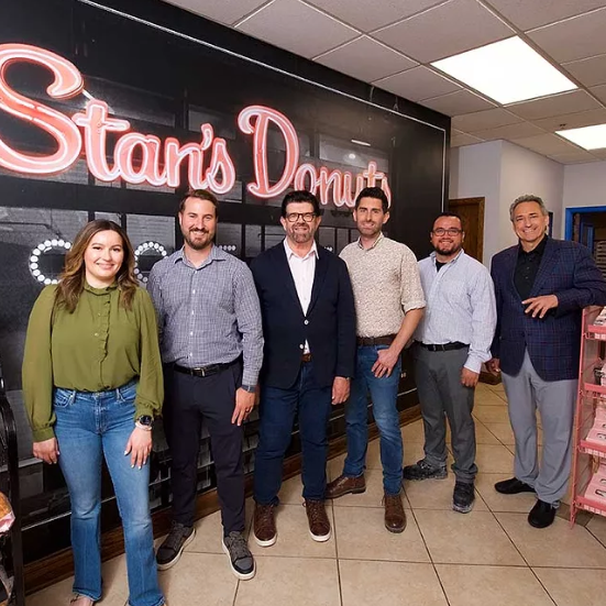 a plate of food and a cup of coffee on a wooden table