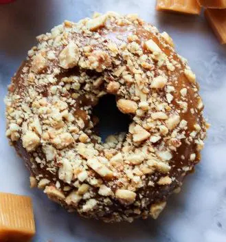 a donut sitting on top of a table a donut sitting on top of a table