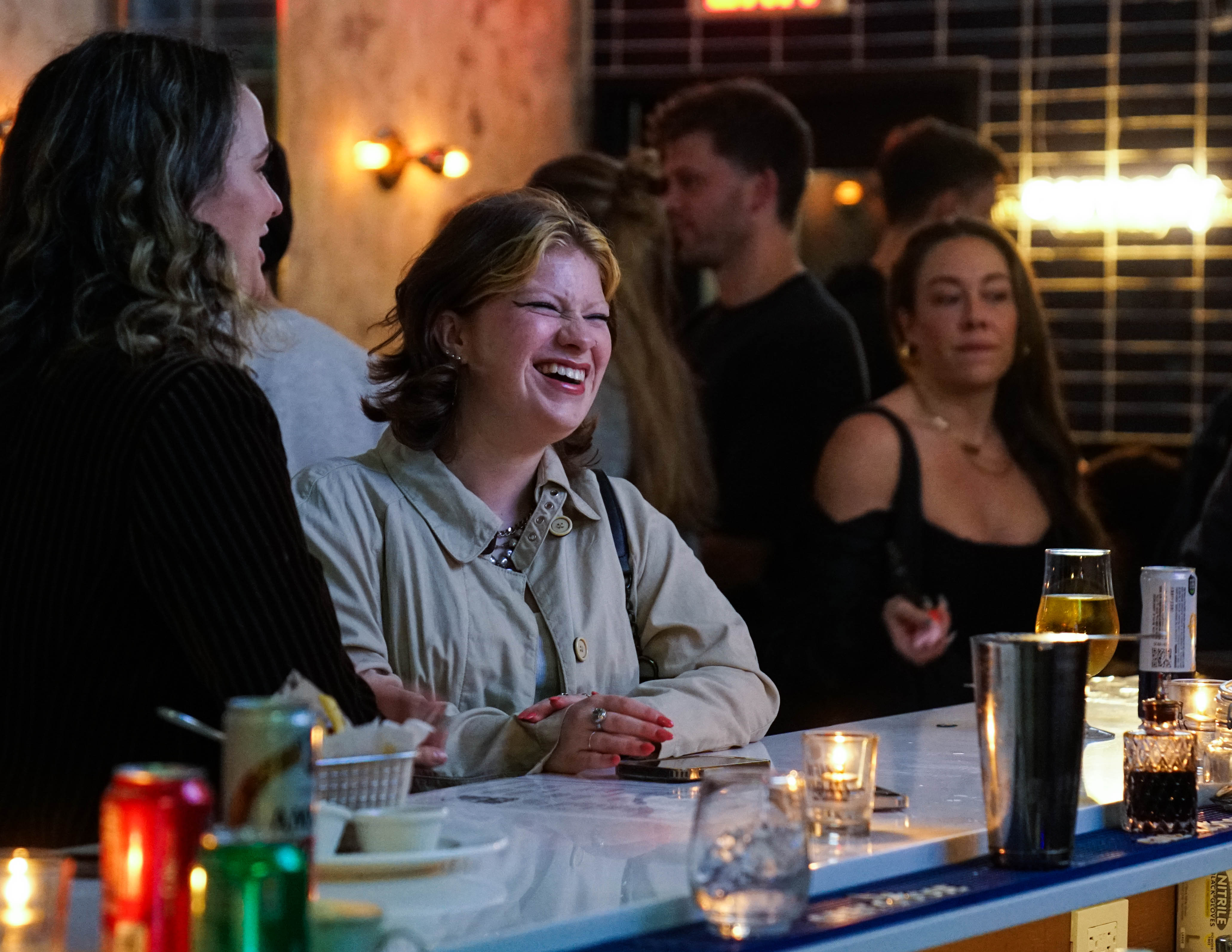 a group of people sitting at a bar