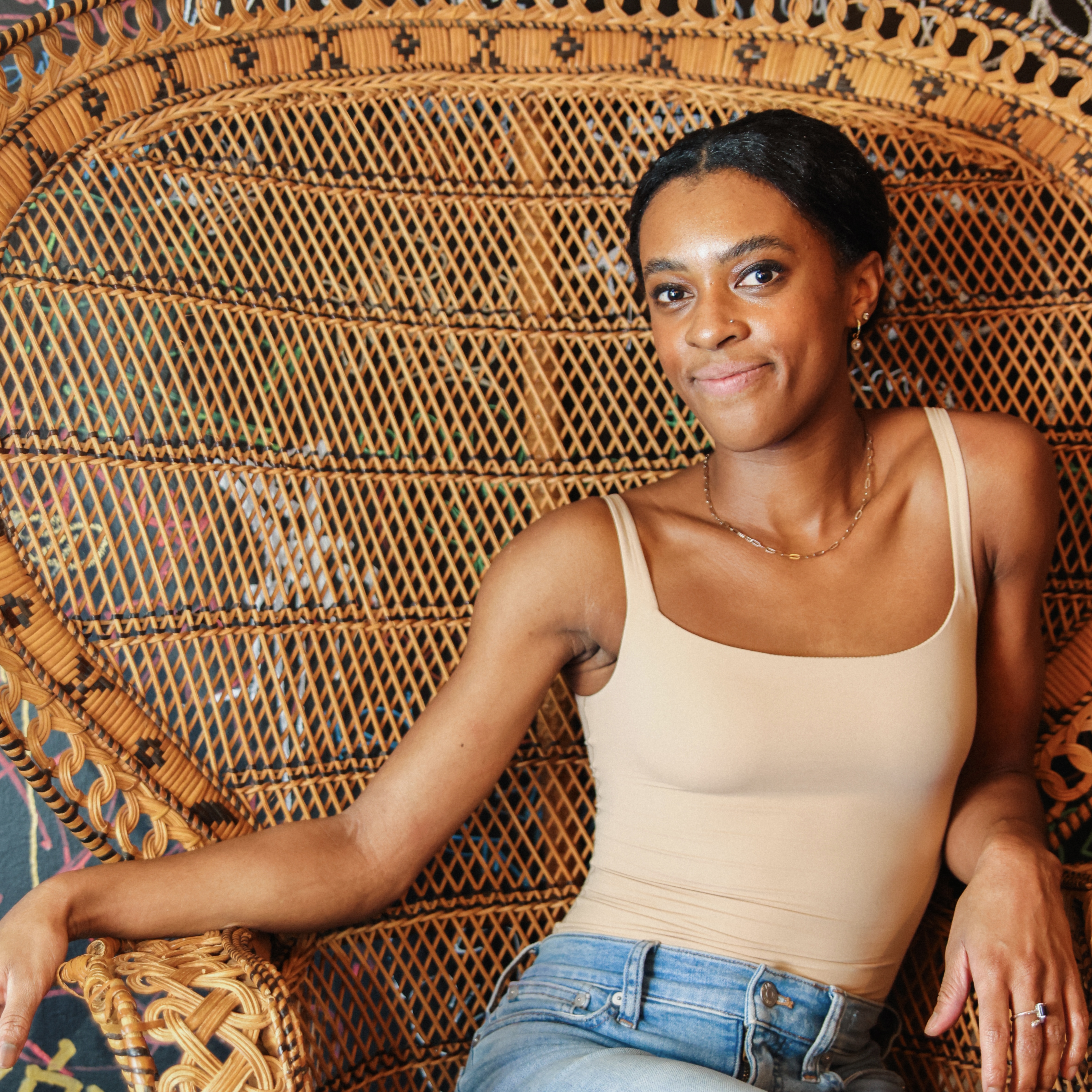 a woman sitting on a bench posing for the camera