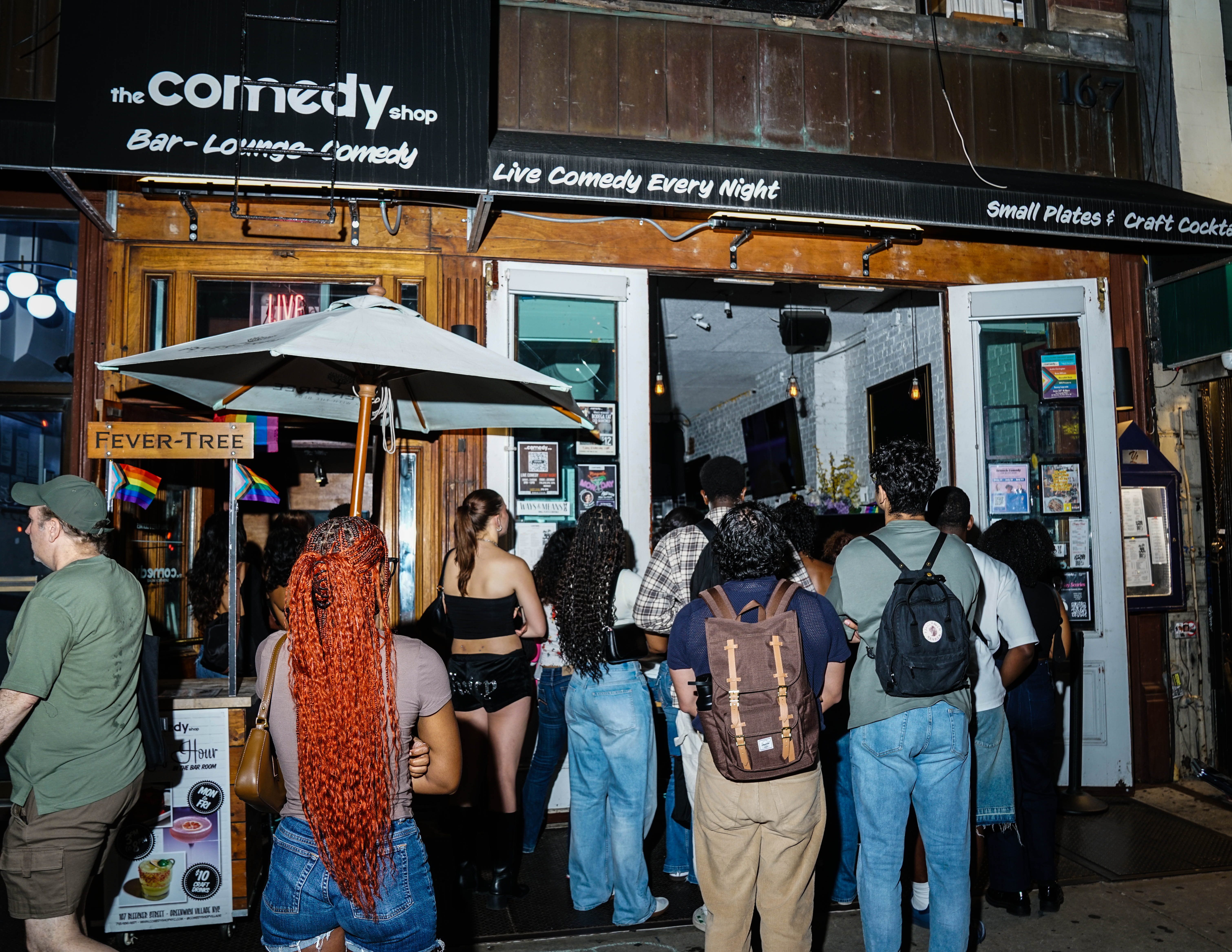 a group of people standing in front of a store