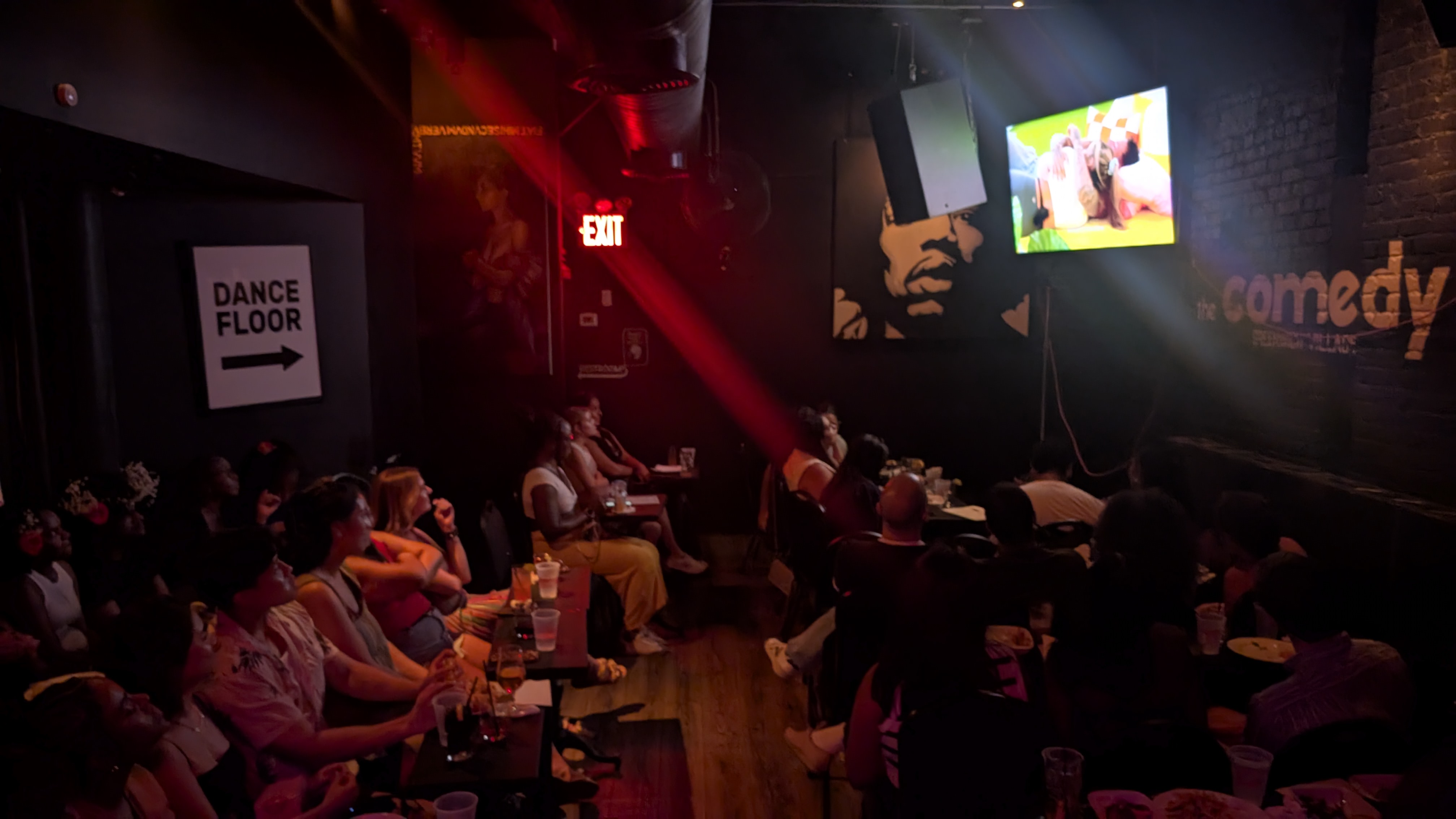 a group of people on a stage in front of a crowd