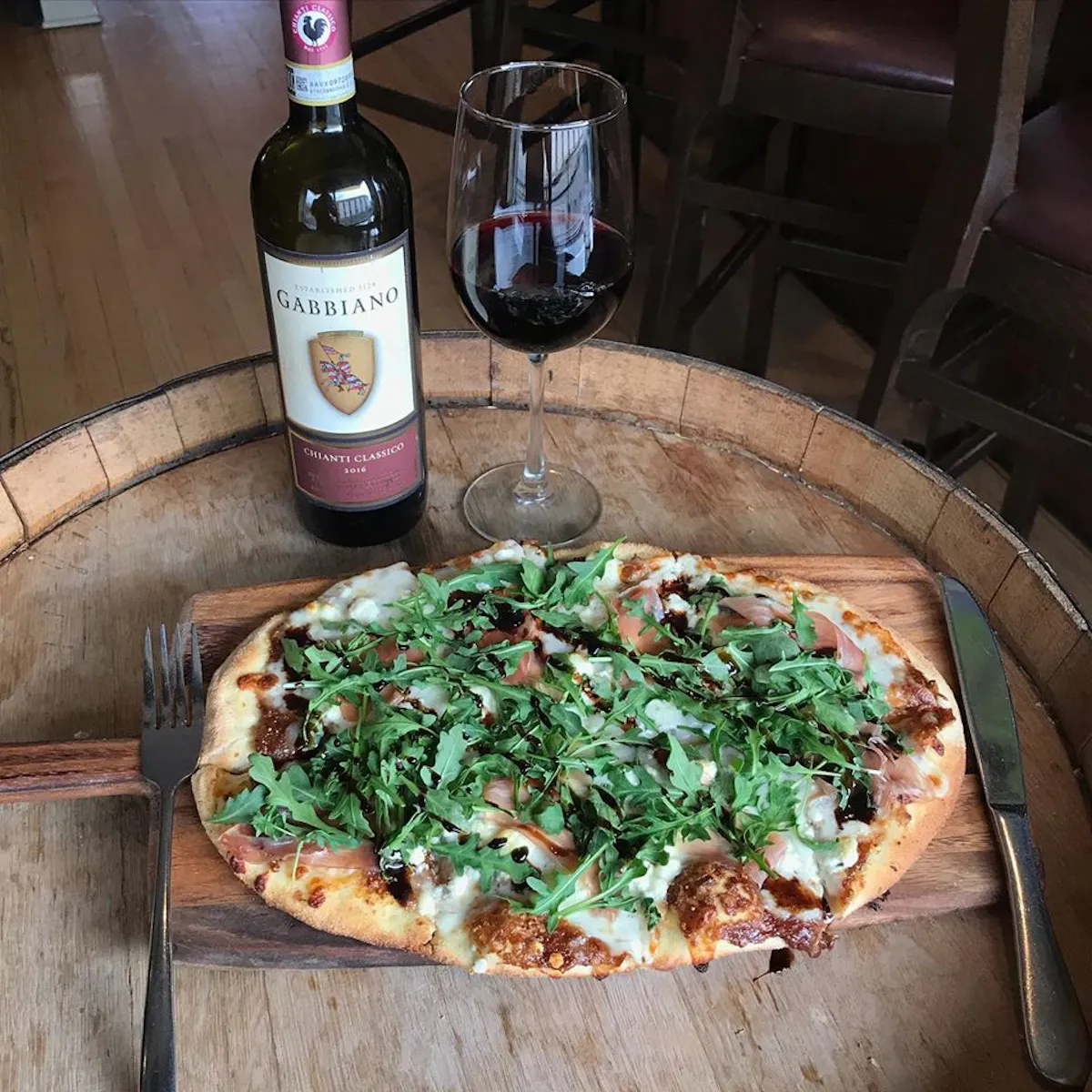 a pizza sitting on top of a wooden cutting board