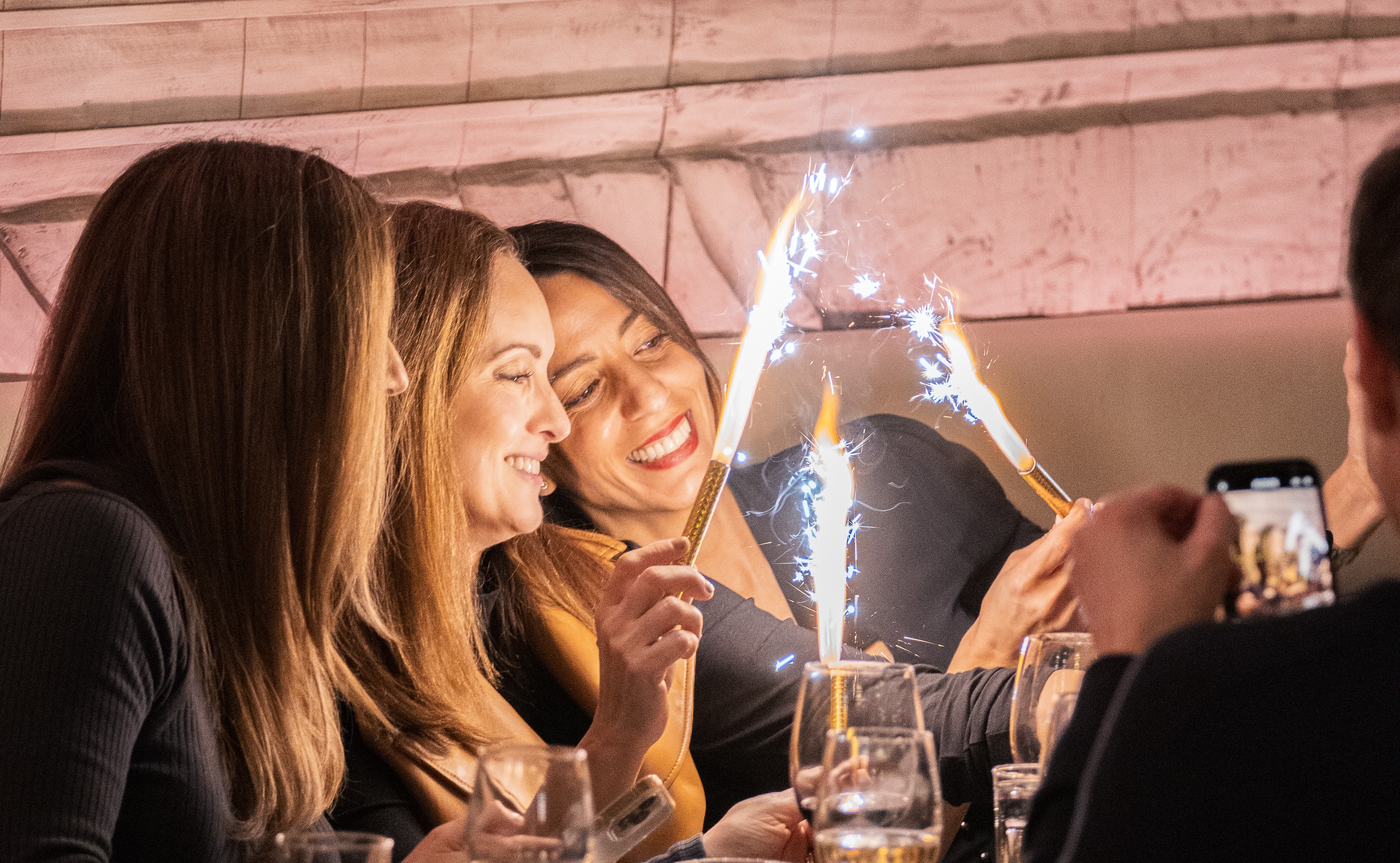 a group of women holding sparklers