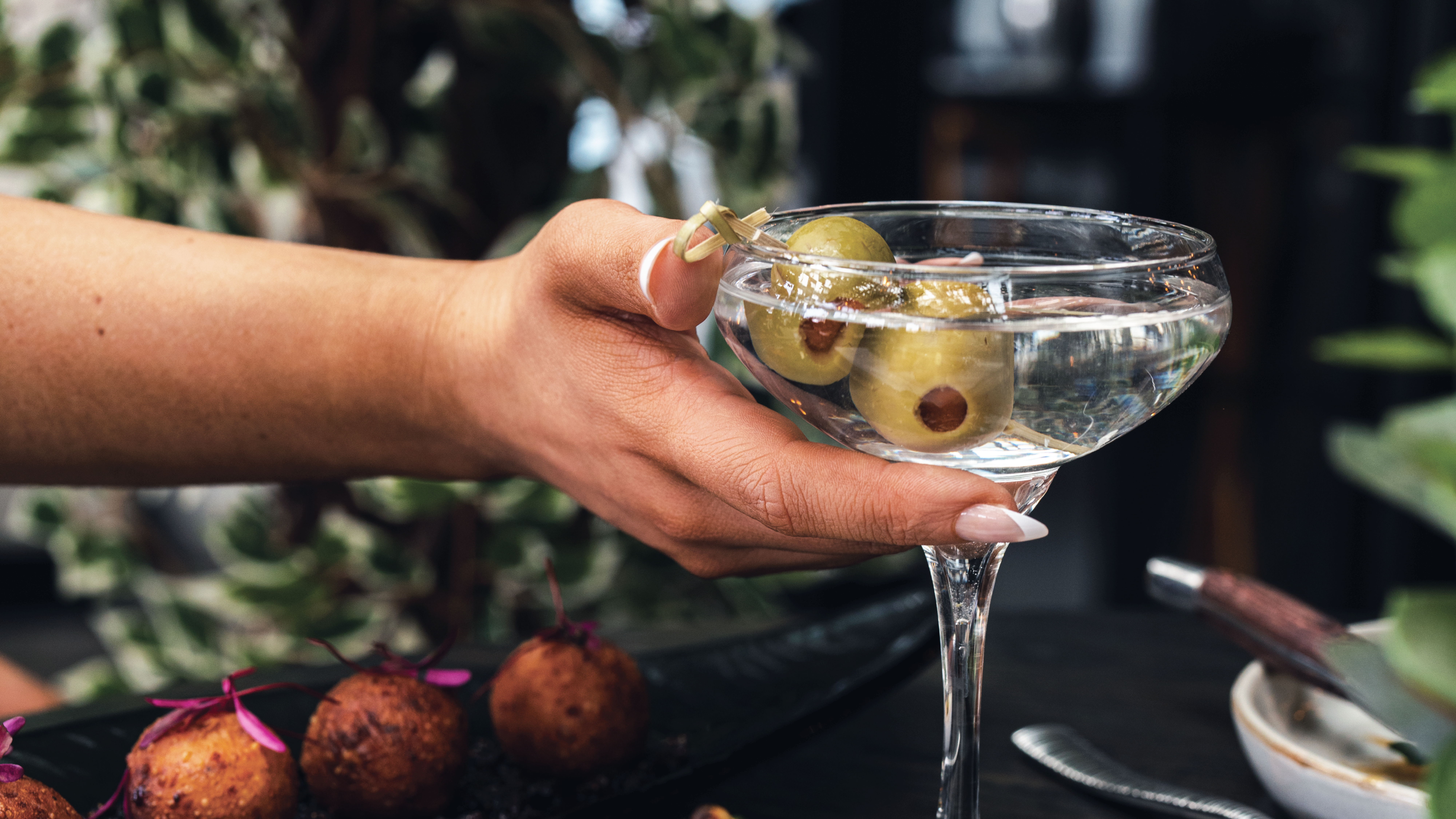 a hand holding a glass of wine