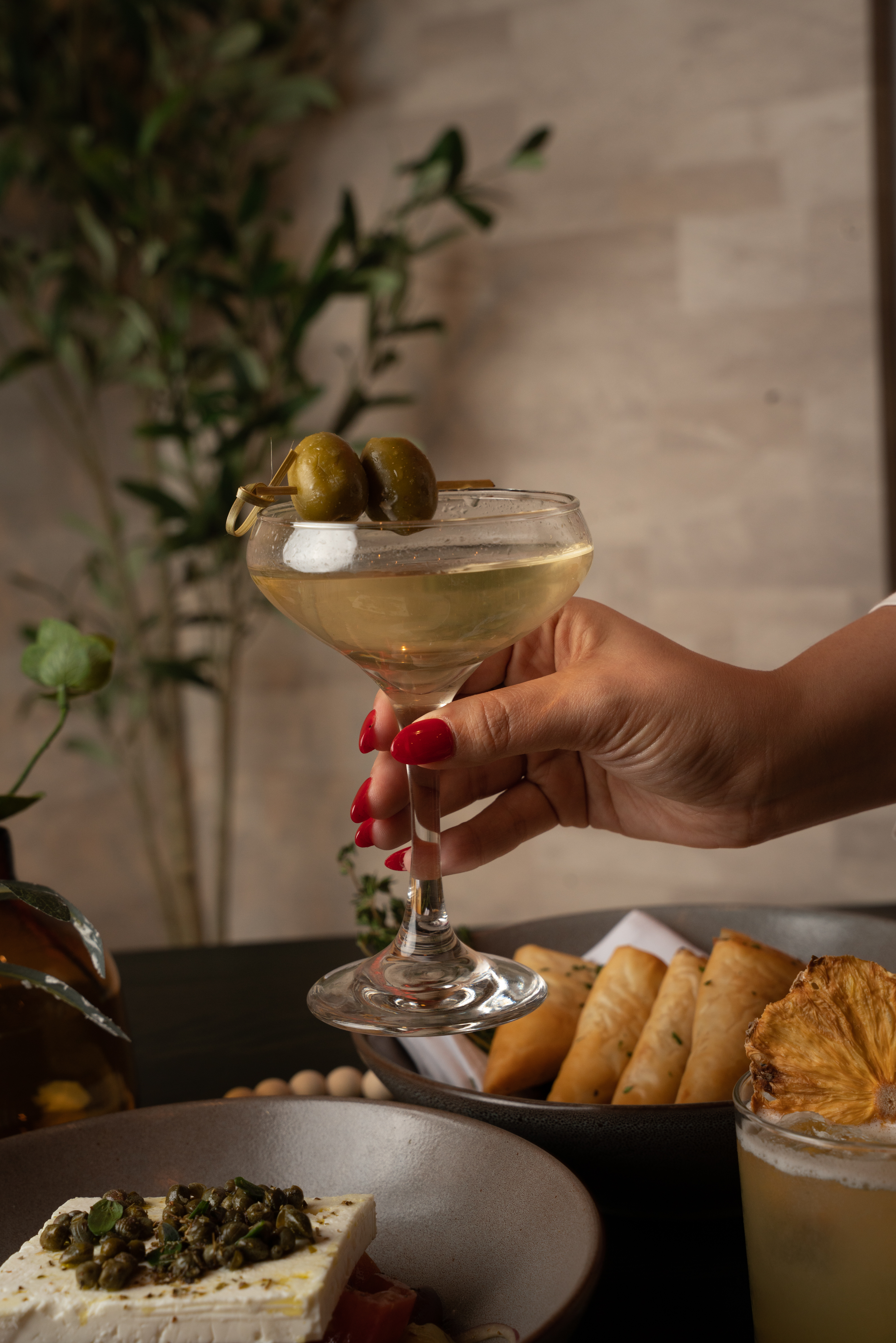 a person holding a plate of food on a table