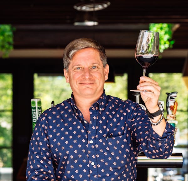 a man holding a glass of wine