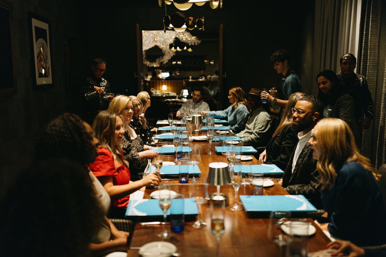 a group of people sitting at a table in a restaurant