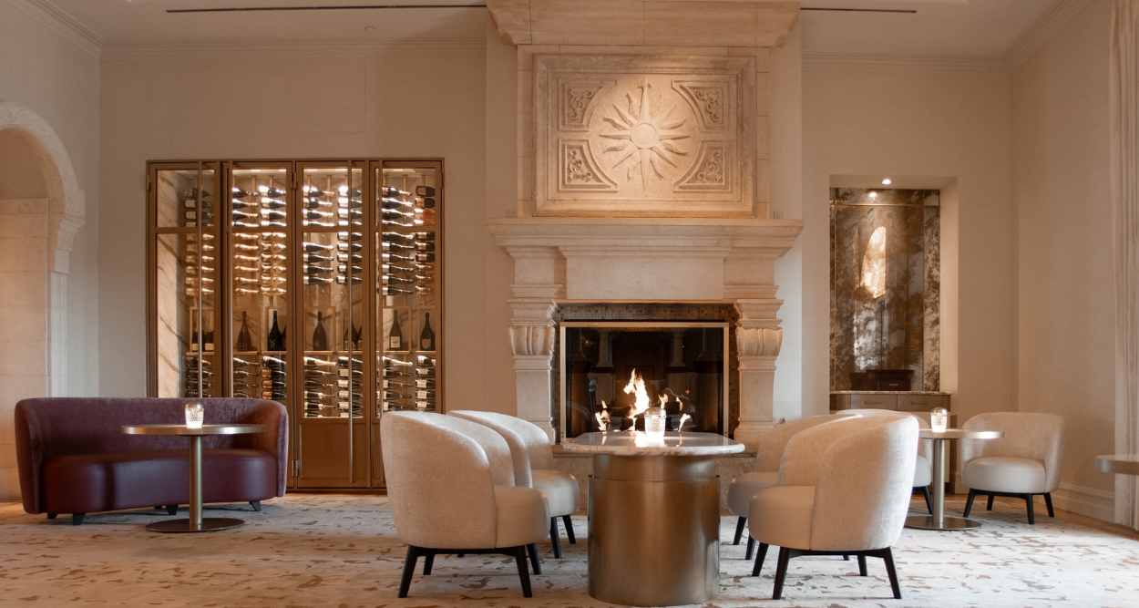 a room with a fireplace and chairs