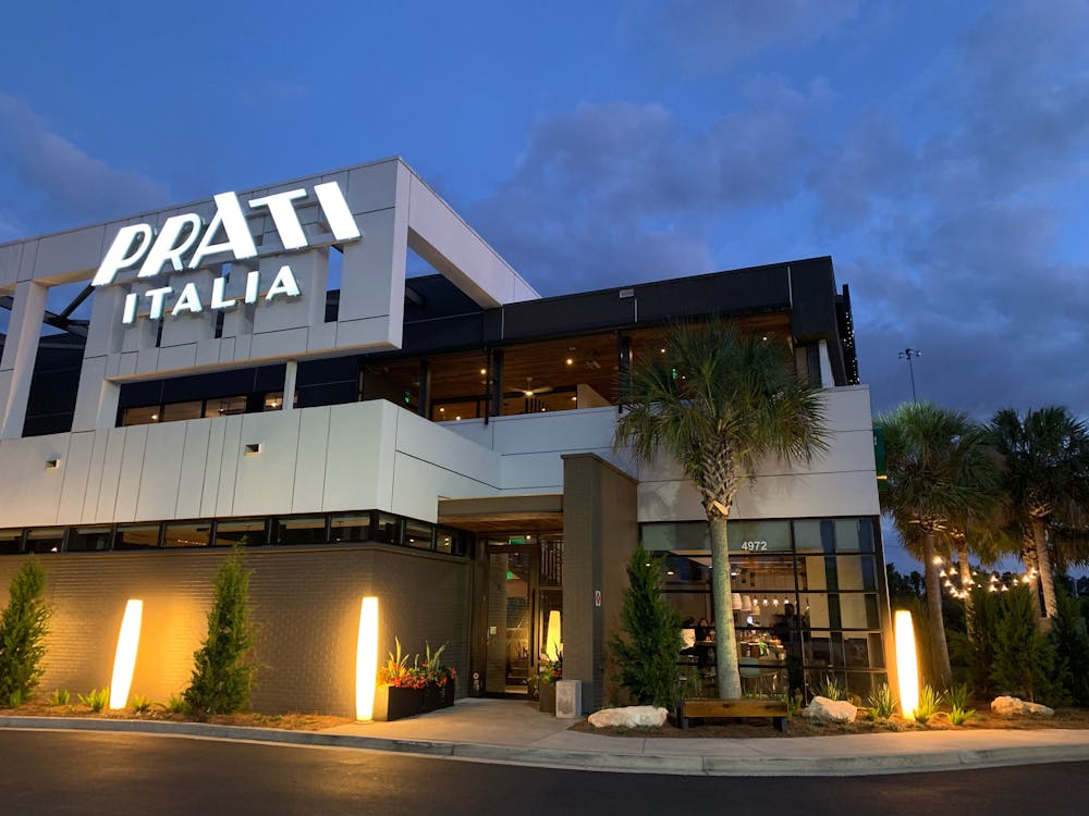 Photo of the exterior front of Prati Italia restaurant from the parking lot.  Shows the Prati Italia sign and main entrance.