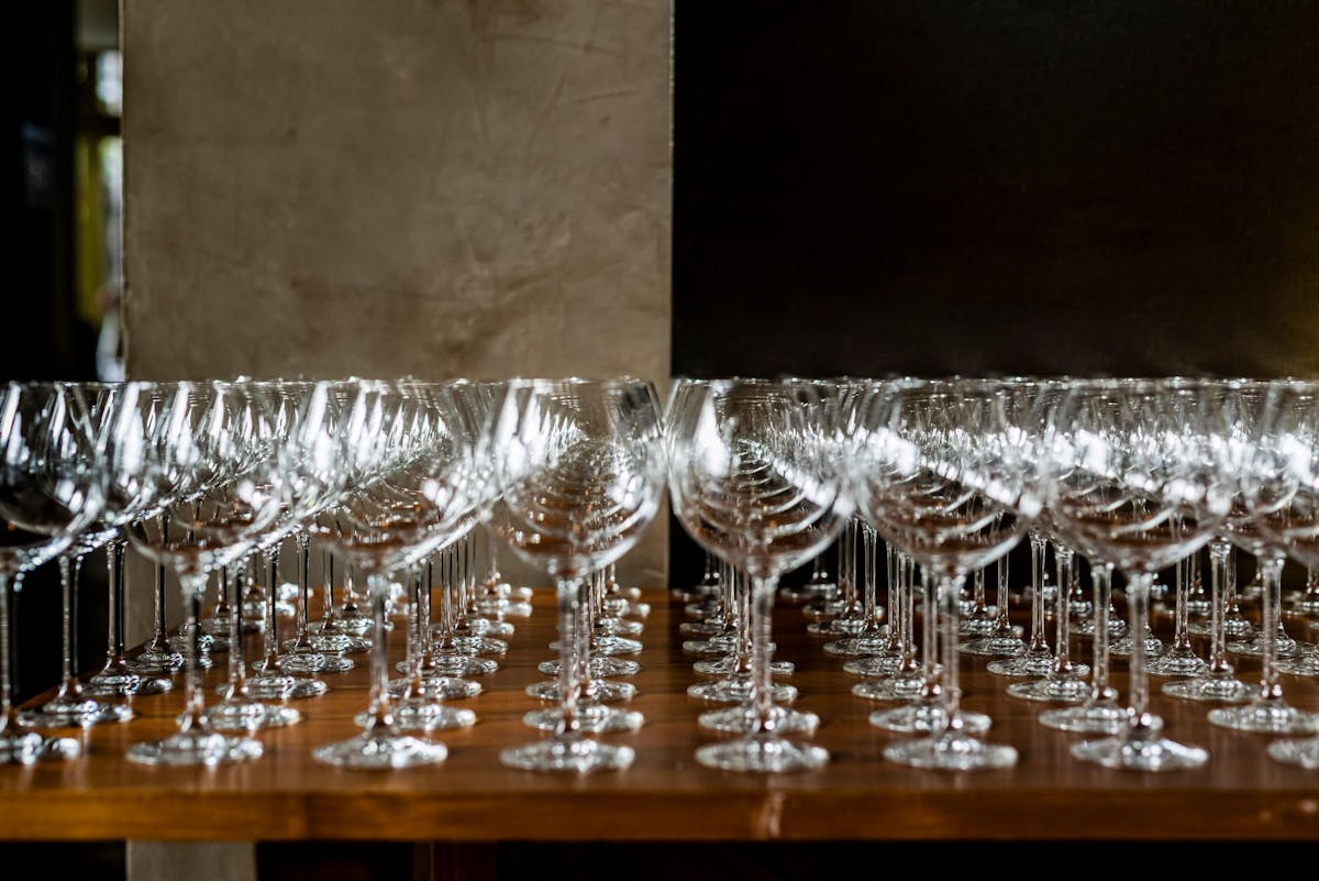 a row of wine glasses on a table