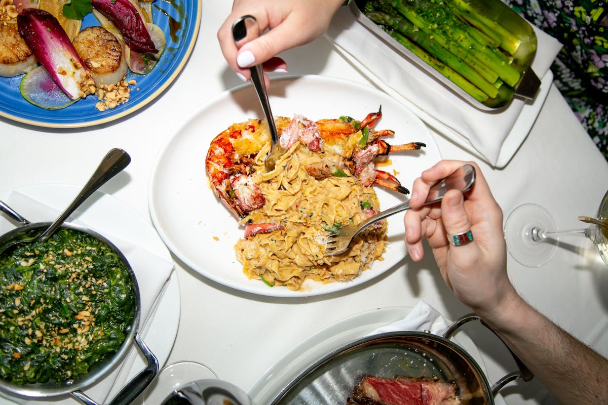 a person sitting at a table with a plate of food