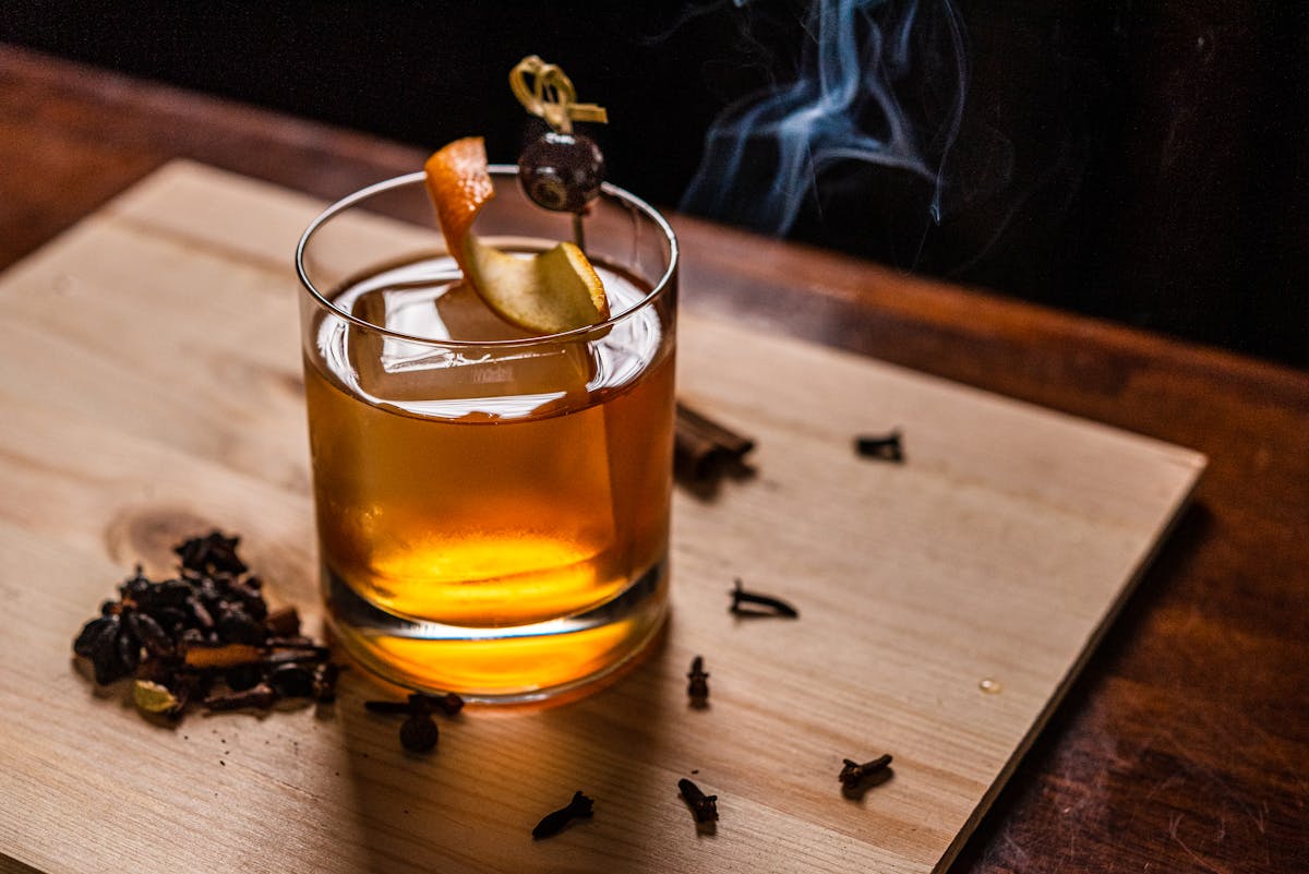 a glass of beer on a wooden table