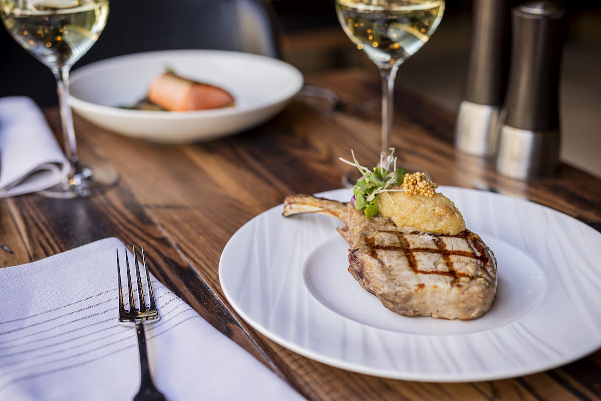 a plate of food and a glass of wine