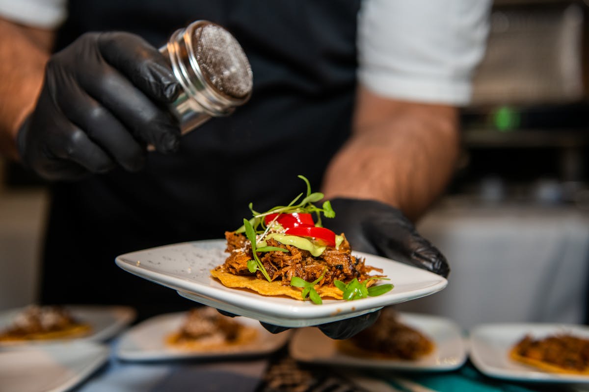 a person sitting at a table with a plate of food