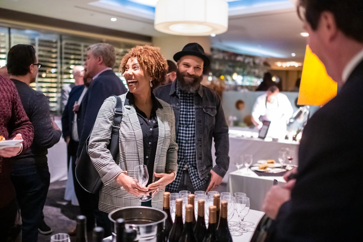 a group of people standing around a table