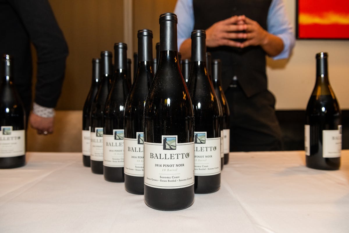 a person holding a bottle of wine